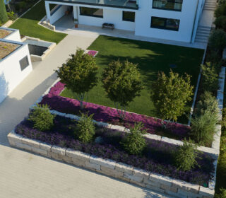 Moderner Vorgarten mit Natursteinmauer, Rasenfläche, blühenden Stauden, kleinen Bäumen und gepflastertem Zugang zum Haus
